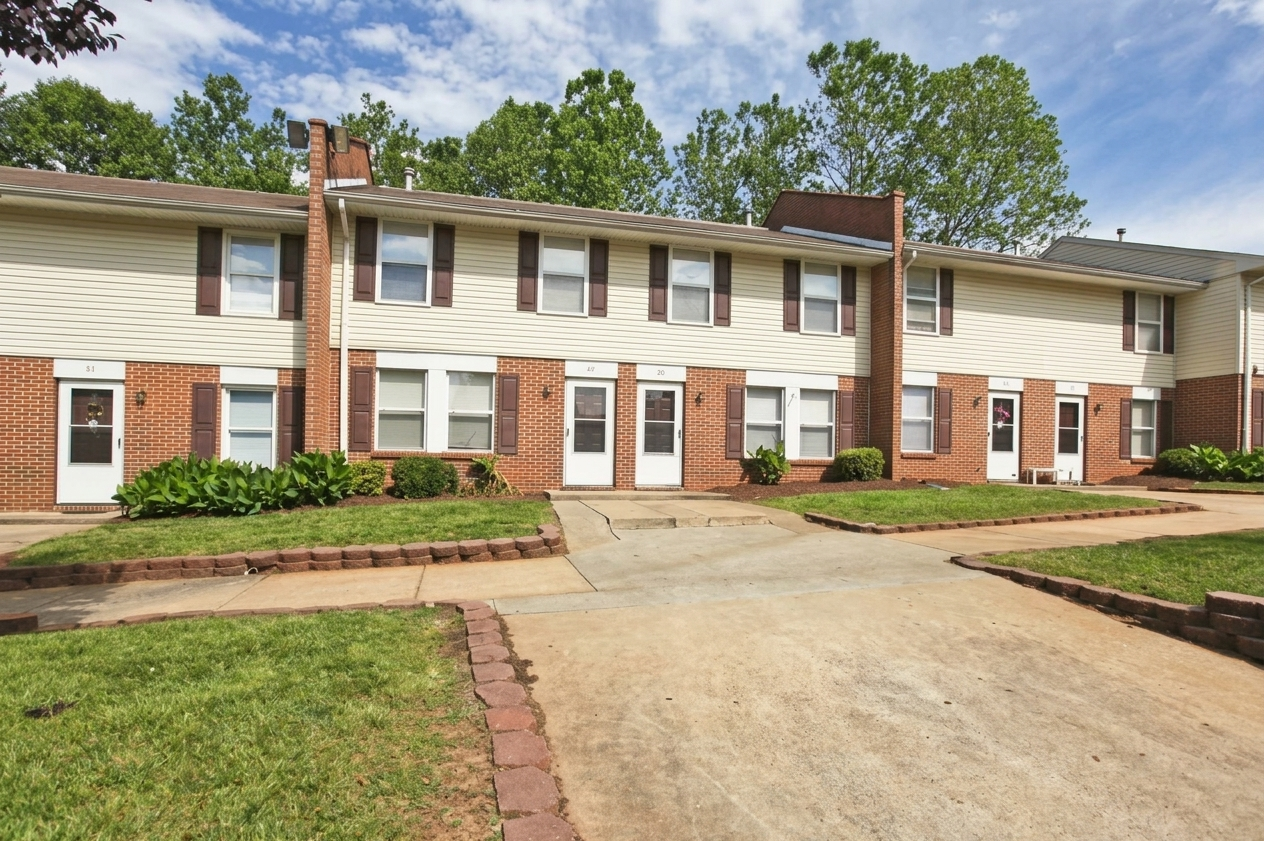 Gretna Village, Gretna, VA — a row of brick and cream-sided townhomes along a curving walk
